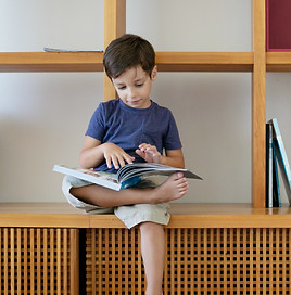 Child reading with a kitten